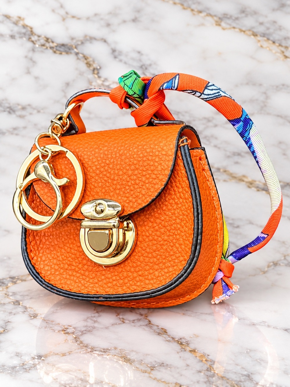 Stylish Orange Mini Saddle Bag with Scarf Handle and Gold Hardware